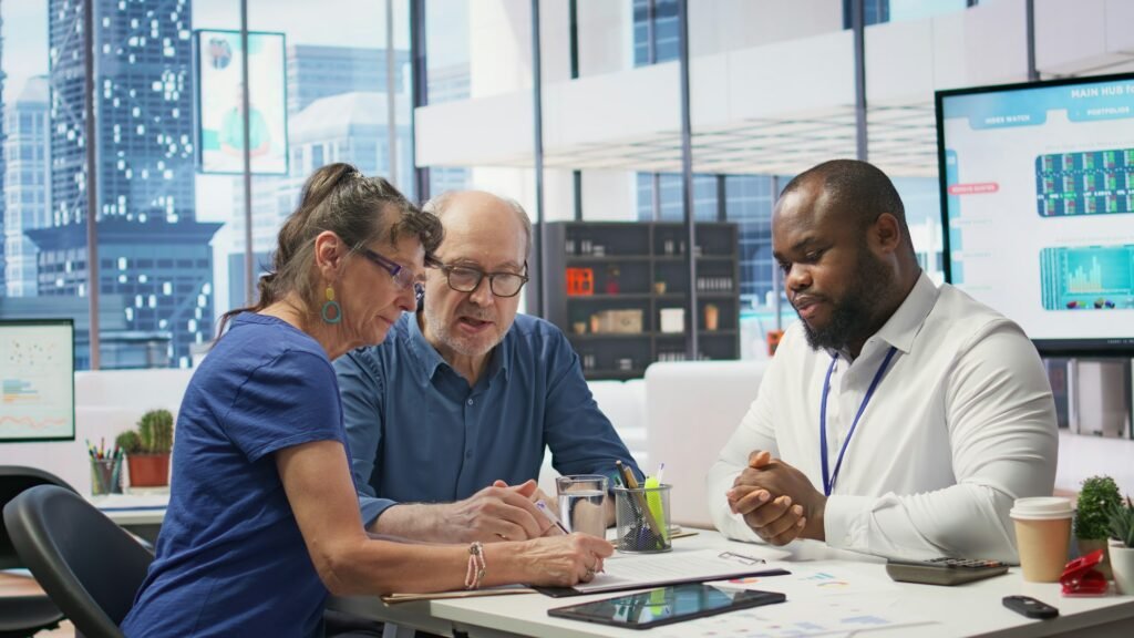 Middle aged couple explores life insurance contract terms with financial adviser